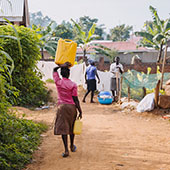 woman carrying a container of water